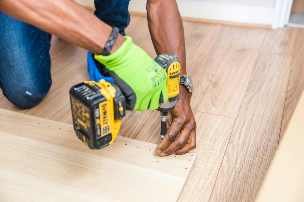 pexels-photo-1249610-1249610 Person Holding Dewalt Cordless Hand Drill